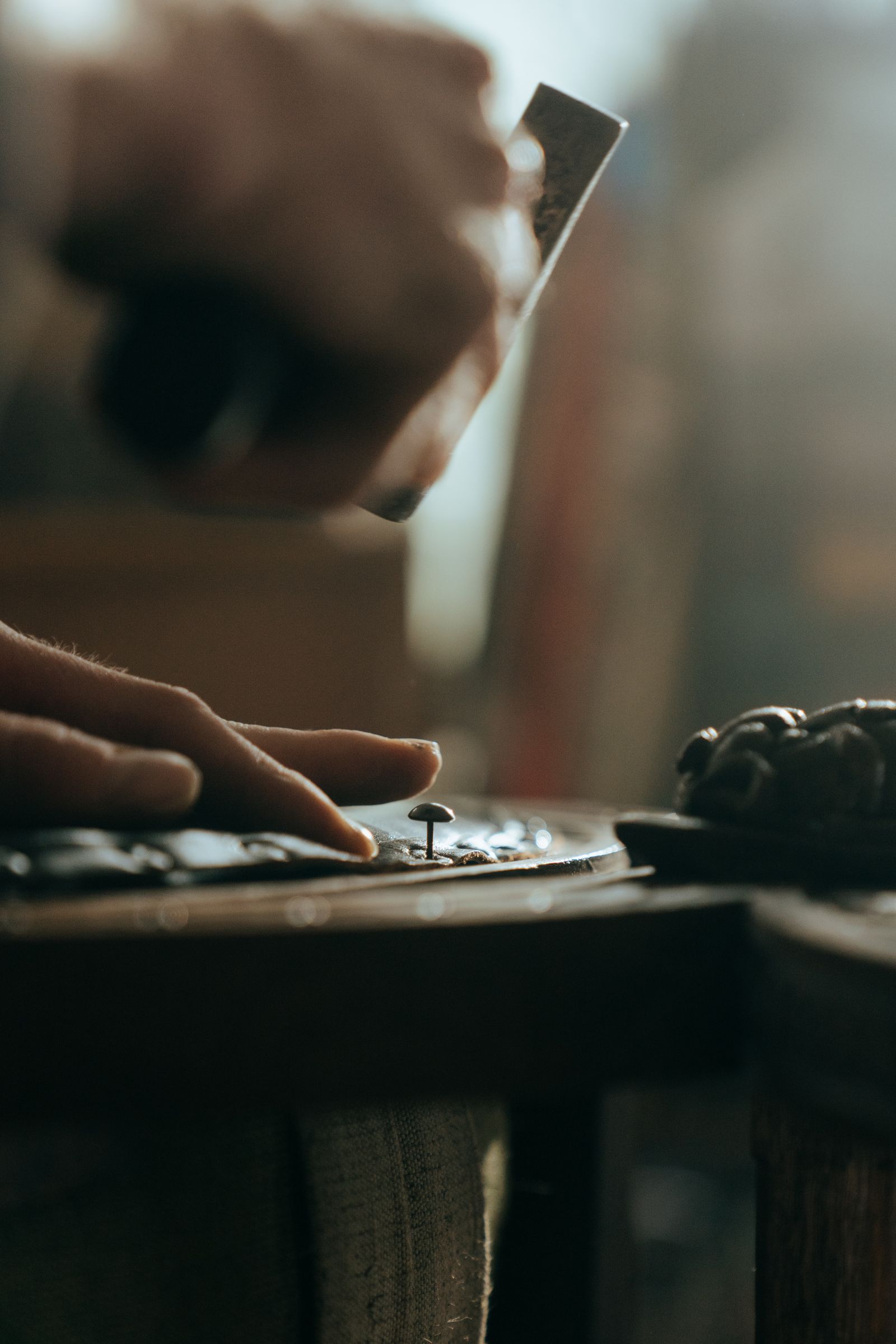 A craftsman carefully restoring a piece of antique wooden furniture in a workshop, demonstrating professional repair techniques